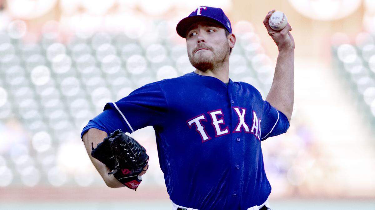 With plenty of empty seats at Globe Life Park, Rangers starter Matt Moore delivers in the first inning Monday against the Tigers. Moore gave up five runs on nine hits in 52/3 innings as his ERA climbed to 7.71 this season.