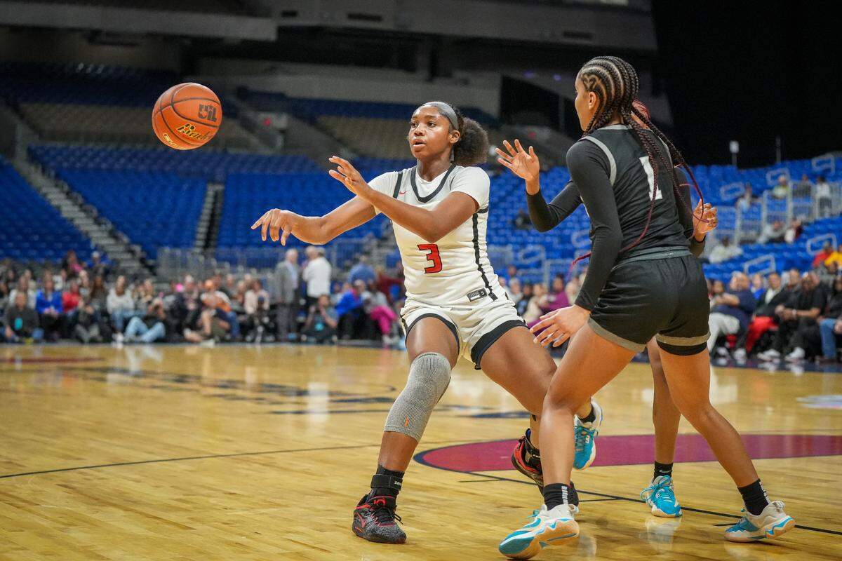 Frisco Liberty’s Jacy Abii dishes off for one of her eight assists against Richmond Randle in a Class 5A state semifinal on Thursday, February 29, 2024 at the Alamodome in San Antonio, Texas. Abii also had 17 points, 18 rebounds and six blocked shots in Liberty’s 66-37 win.