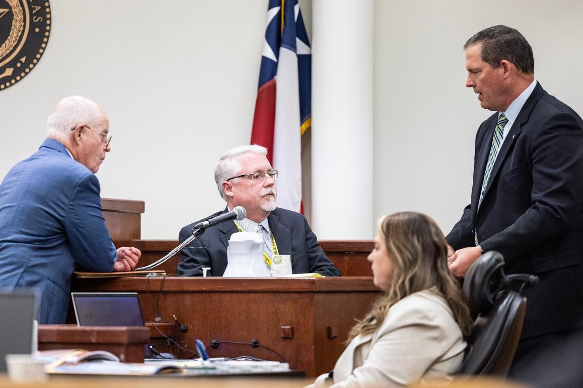 Defense attorney Jack Strickland, left, and Assistant Criminal District Attorney Lloyd Whelchel, right, speak with Tarrant County Medical Examiner’s Office Deputy Chief Forensic Death Investigator Stephen White on the witness stand at Carl Brewer’s trial at the Tim Curry Criminal Justice Center in Fort Worth on Wednesday, May 29, 2024. Brewer was accused of shooting to death his adoptive parents, Troy Brewer and Mary Brewer, in November 2016 in Crowley.