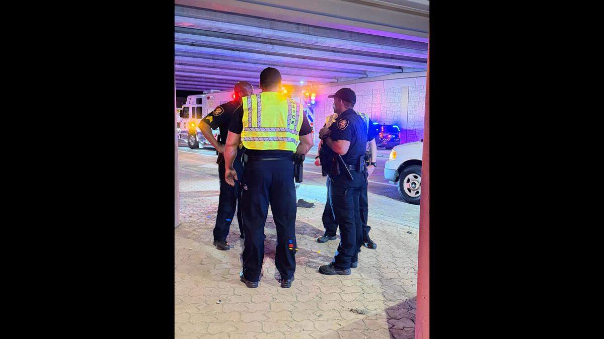 Fort Worth police officers work Monday, March 30, 2026, at the scene of a fatal wreck where a woman drove an SUV over a wall on Interstate 35W and crashed onto the road below. the driver was killed in the crash and two children were injured.