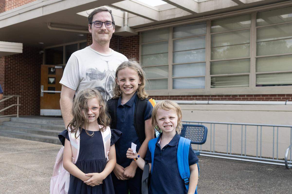 Riverside parent William Sheppard is photographed with his kids Kairi, 6, Corbyn, 5, and Daxter, 8, after school gets out at Riverside Applied Learning Center in Fort Worth on Tuesday, Aug. 19, 2025.
