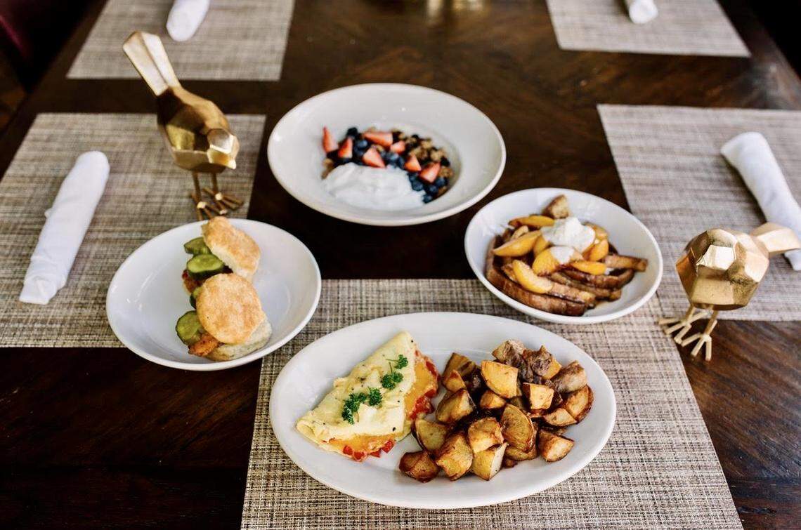 A brunch package at Bird Cafe with a pimiento omelet, chicken biscuits, peach-cinnamon French toast and yogurt with berries.