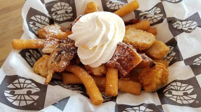 Hawg Heaven Funnel Fries at Texas Motor Speedway come with popcorn chicken nuggets, bacon-infused syrup, maple candided bacon, a whipped topping and more.