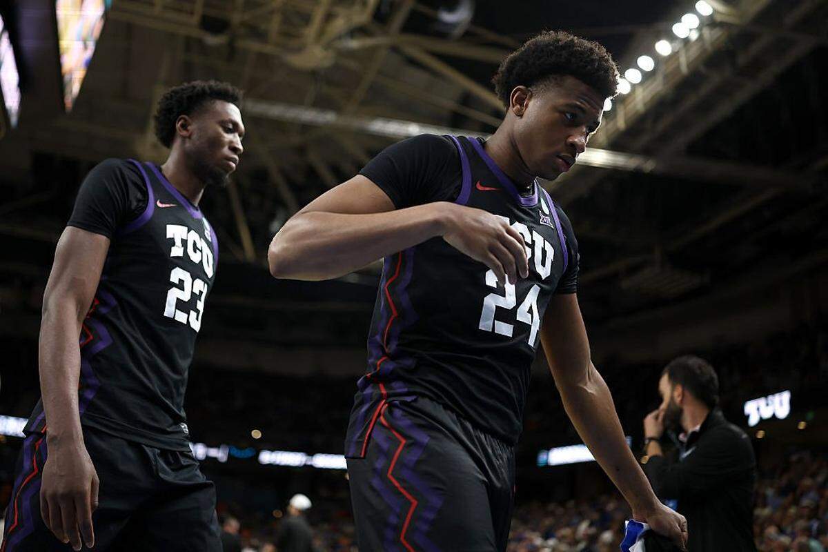 GREENVILLE, SOUTH CAROLINA - MARCH 21: Vianney Salatchoum #23 and Xavier Edmonds #24 of the Texas Christian University Horned Frogs walk off the court after the game against the Duke Blue Devils in the second round of the 2026 NCAA Men's Basketball Tournament at Bon Secours Wellness Arena on March 21, 2026 in Greenville, South Carolina. The Blue Devils defeated the Horned Frogs 81-58. (Photo by Jared C. Tilton/Getty Images)