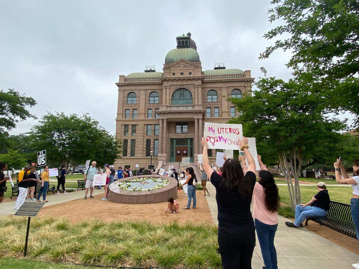 Dozens of abortion rights supporters gathered outside the Tarrant County Courthouse Saturday morning protesting against a leaked draft decision from the Supreme Court to overturn Roe v. Wade.