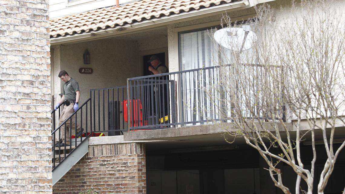 Investigators work at the scene of a double homicide Friday at a condominium at Shady Oaks Drive and Woodhaven Boulevard in east Fort Worth.