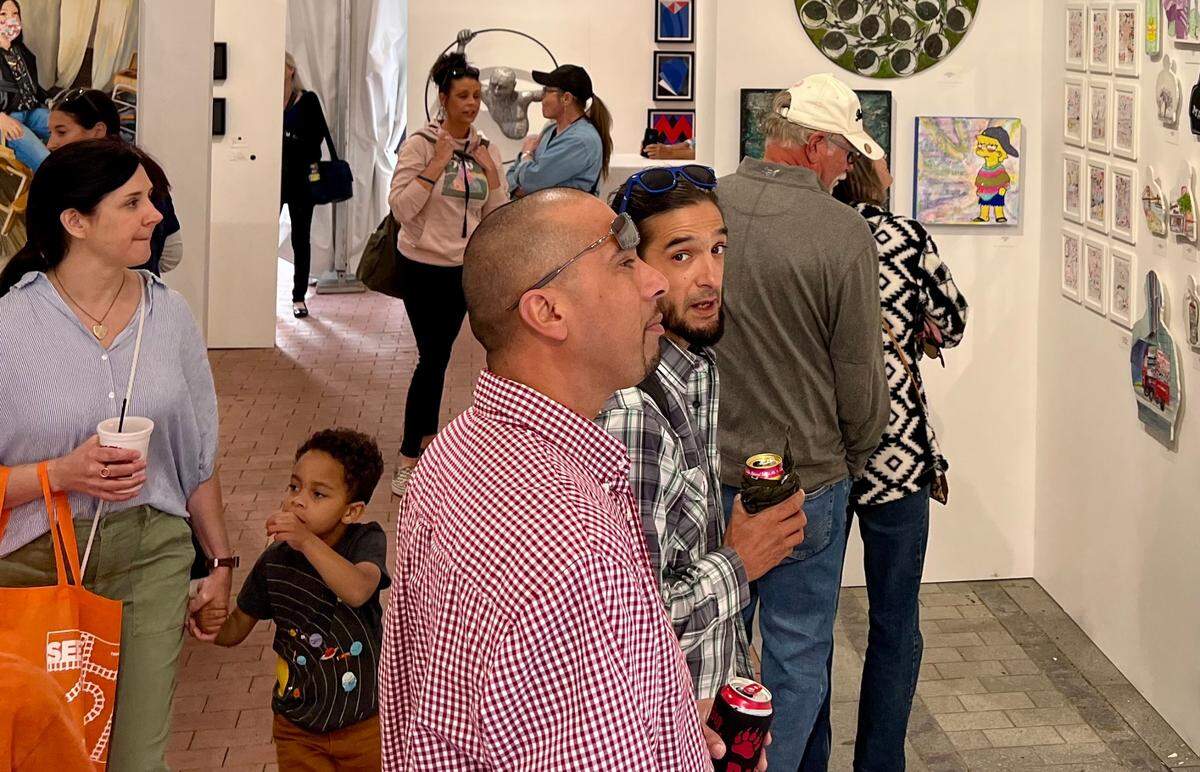 Festivalgoers browse local artists’ work inside the Fort Worth Art Fair.