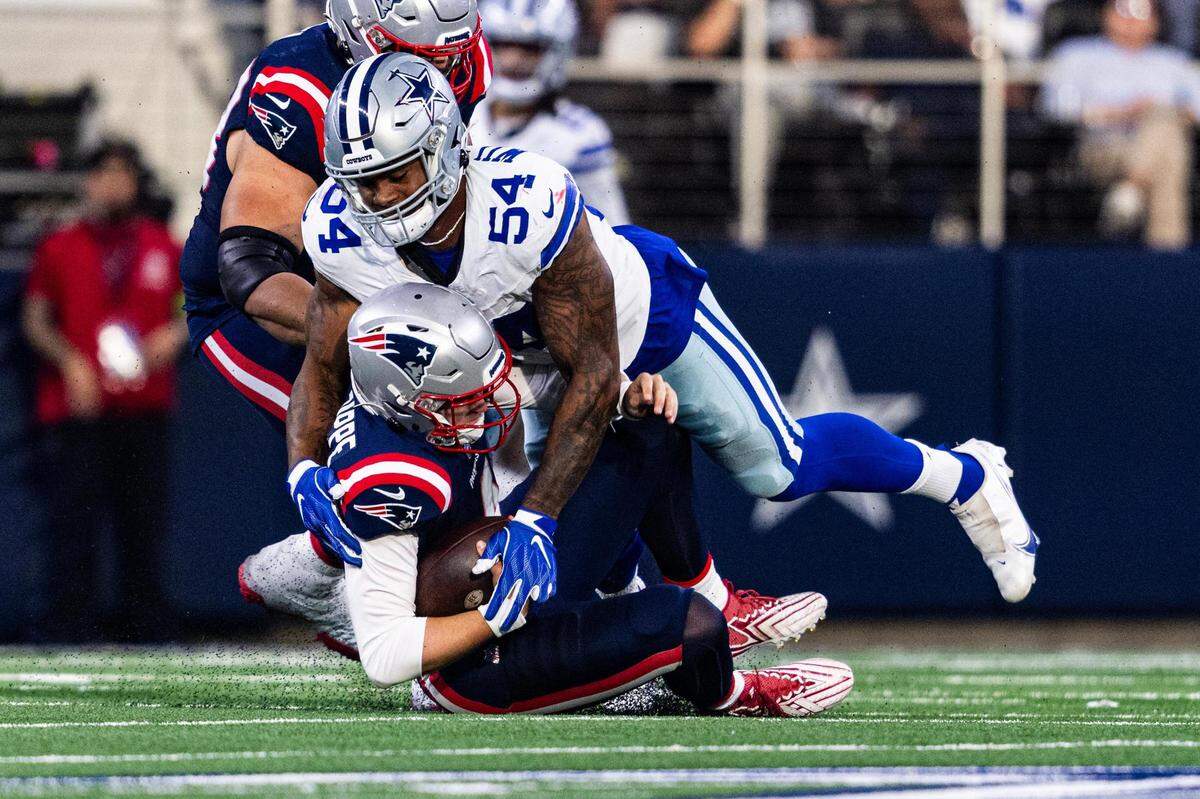 Patriots quarterback Bailey Zappe (4) is sacked by Cowboys defensive end Sam Williams (54) in the second half of an NFL game between the Dallas Cowboys and New England Patriots at AT&T Stadium in Arlington on Sunday, Oct. 1, 2023. The Cowboys defeated the Patriots 38-3.