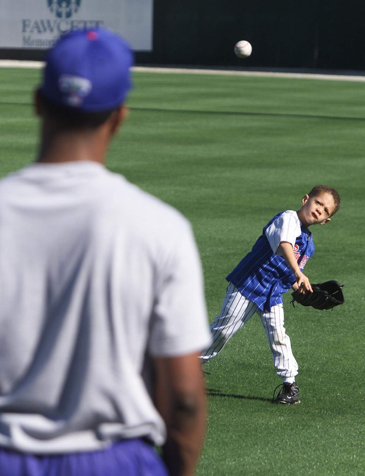 Texas Rangers pitcher Pat Mahomes waits for the toss from his son Patrick Mahomes (age 5) during the 2001 training camp.