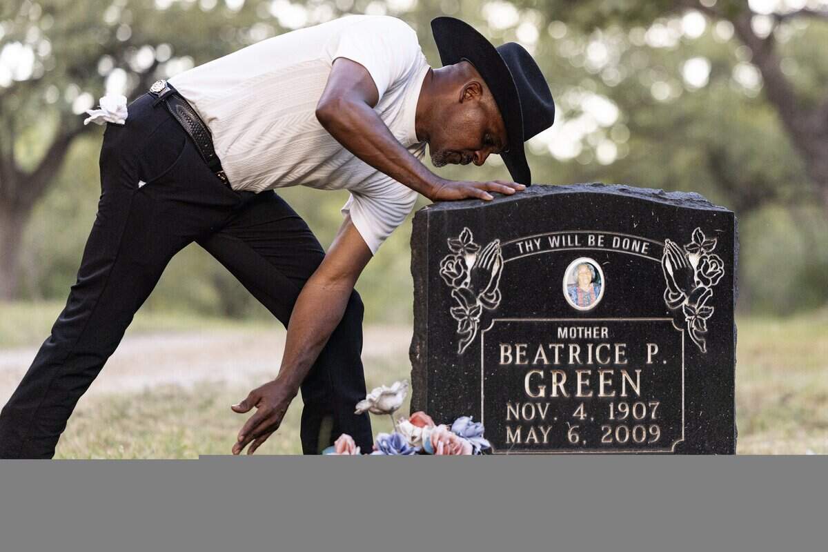 Jeff Pointer cleans off his great grandmothers grave stone at Mosier Valley Ancestor Cemetery on Wednesday, Sept. 24, 2025. Pointer, along with other members of the Mosier Valley Community,is working to protect and develop their community which has for decades been neglected.