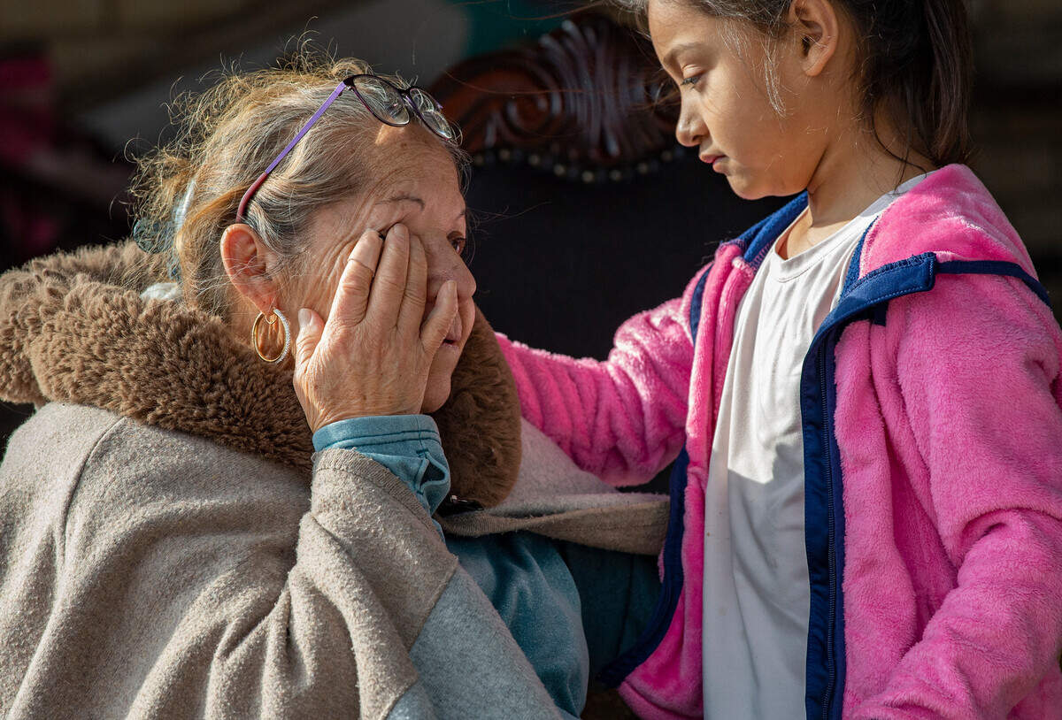 Bertha Gonzalez is comforted by her granddaughter Isa. Both were in the house when the twister hit. A tornado touched down just south of Decatur, Texas, along FM 730 early morning Tuesday, Dec. 13, 2022, tearing the roof off of a home and ripping trees in half. Debris was strewn across the highway.