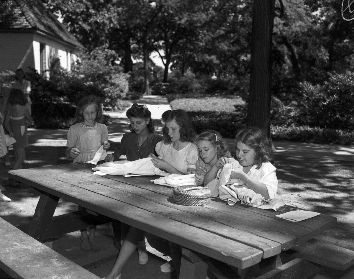July 11, 1943: Girl Scouts at summer camp learn to sew baby blankets and wash cloths and embroidery. From left: Doris Jean Page, Martha Pullen, Mary Ruth Spillers, Merle Killgo, and Vivian Farmar.