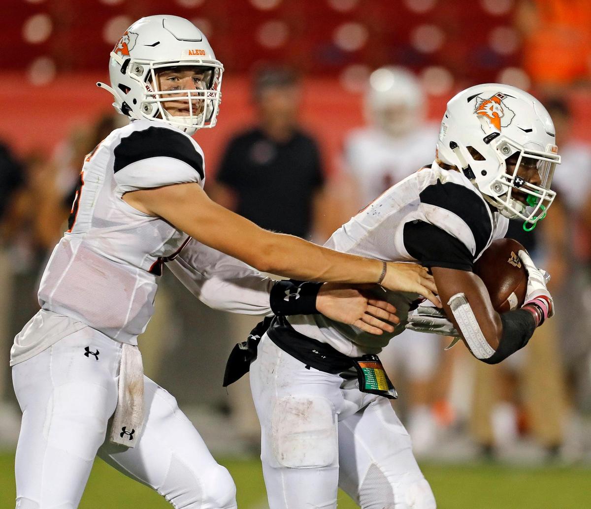 Aledo quarterback Brayden Fowler-Nicolosi (16) hands the ball off to running back Ryan Williams (5) during a high school football game at Toyota Stadium in Frisco, Texas, Thursday, Sept. 02, 2021. Aledo defeated Lone Star 45-35. (Special to the Star-Telegram Bob Booth)