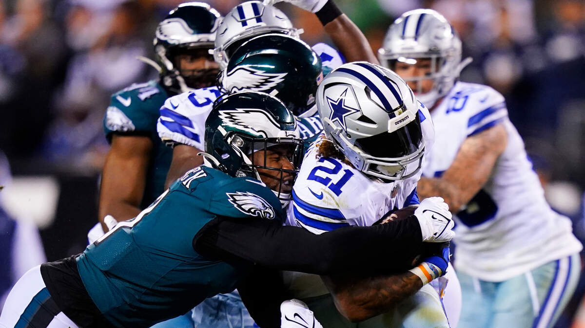Dallas Cowboys’ Ezekiel Elliott is stopped by Philadelphia Eagles’ Haason Reddick during the second half of an NFL football game Sunday.