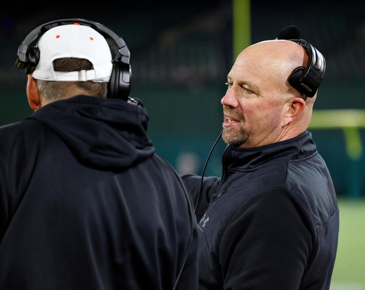 Aledo head coach Robby Jones talks with one of his staff on the sidelines in a Conference 5A Division 1 UIL Regional football playoff game at Choctaw Stadium in Arlington, Texas, Friday, Oct. 24, 2023.