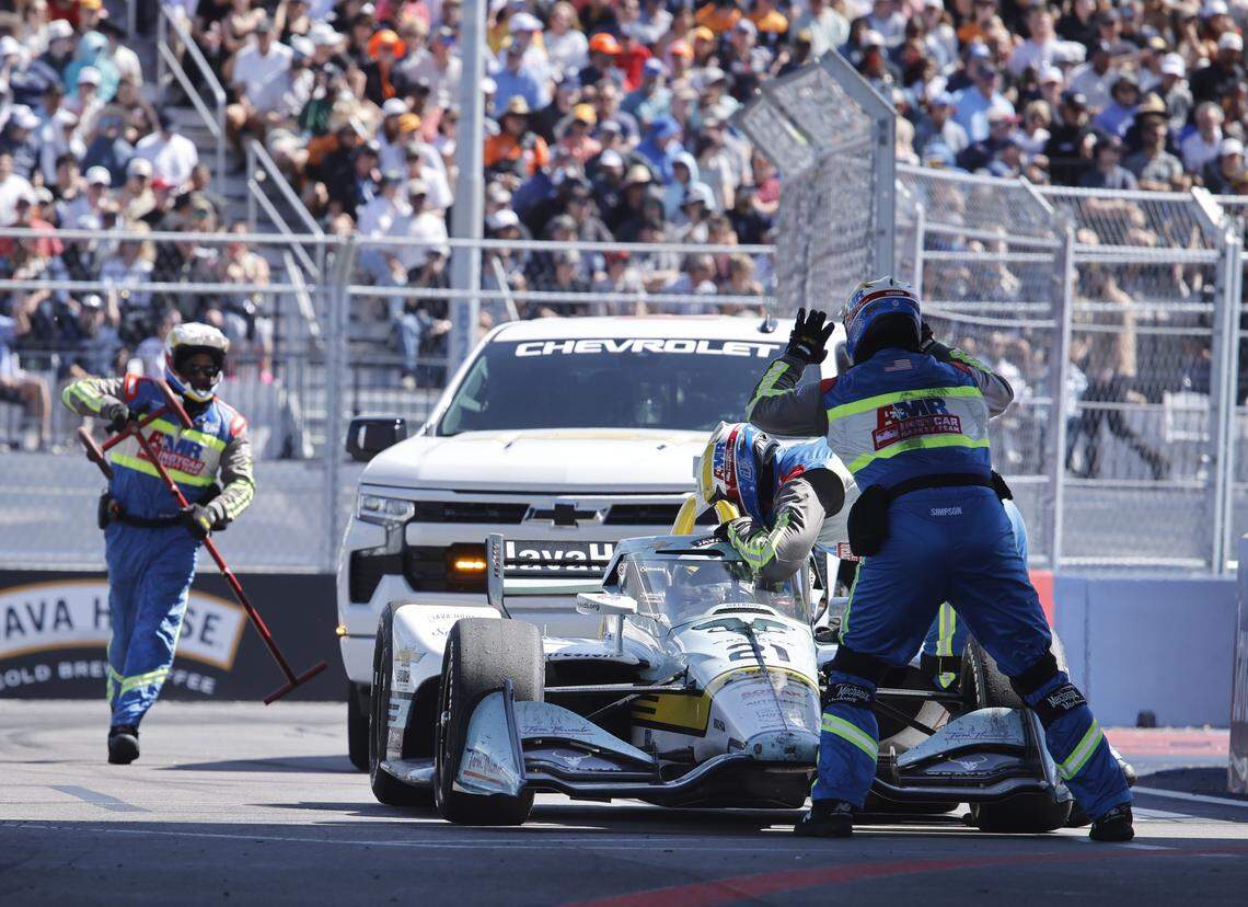 The safety team removes the ECR Chevrolet driven by Christian Rasmussen (21) from the track during the inaugural Java House Grand Prix of Arlington in Arlington, Texas, Sunday, March, 15, 2026.