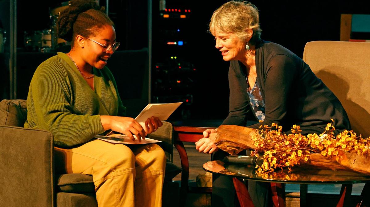 Tajanae Harris, left, a descendant of a slave, met Rebecca Bradshaw for the first time this week after learning that Bradshaw is a descendant of the family that owned Harris’ relative, Delia. Here, they look through family memorabilia during “The Conversation: A Story in Black and White” in the sanctuary at the Well Church in Keller on Tuesday, Nov. 12.
