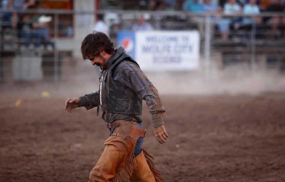 Josh Bethel of Wolfe City walks out of the arena after competing in the ranch bronc riding event at the Wolfe City Rodeo on Friday, Aug. 5, 2022.