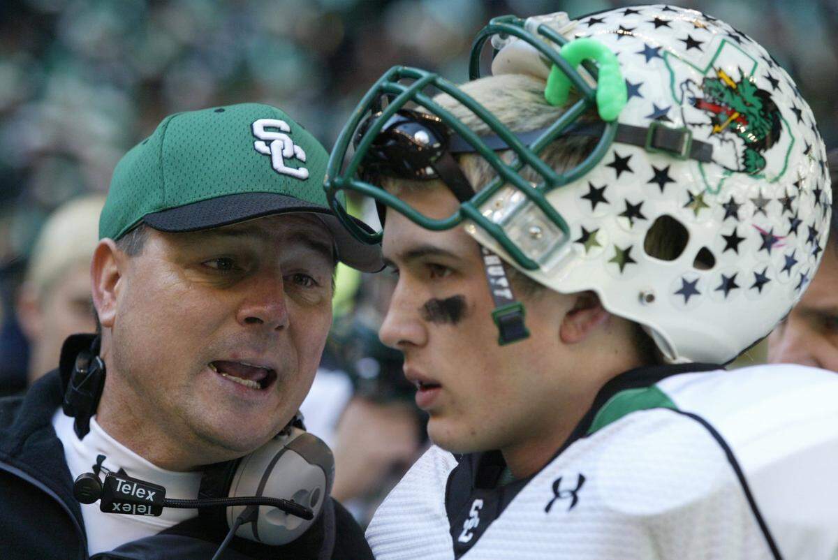 Southlake Carroll’s Riley Dodge listens to head coach Todd Dodge just before a playoff game against Colleyville Heritage on Dec. 9, 2006, at Texas Stadium in Irving.
