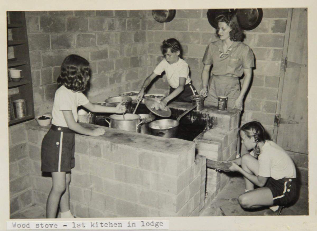 Photo of Girl Scouts cooking on the first stove at Camp Timberlake in the 1940s.
