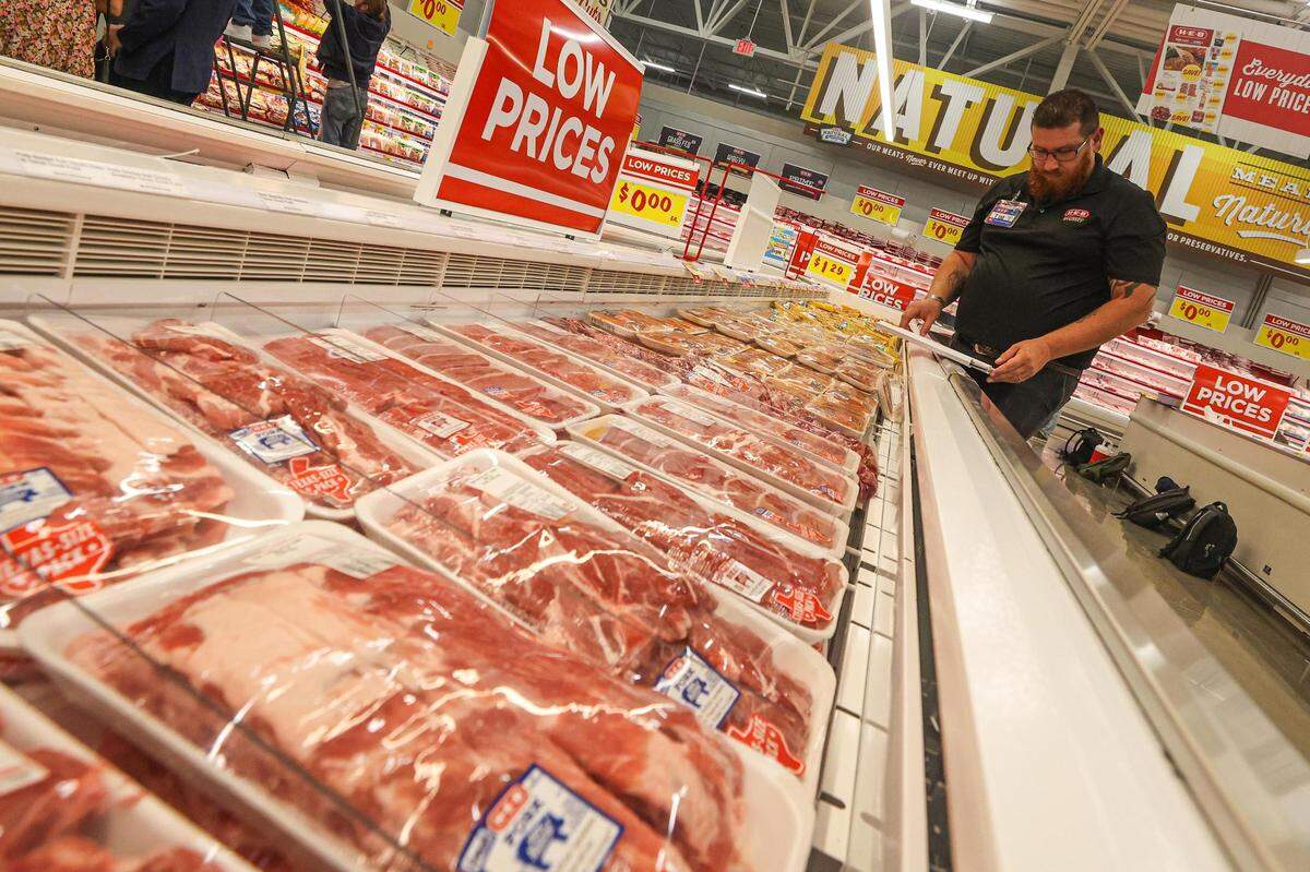 Meat Department Manager Tim Martin puts price tags on the package meats to prepare for the grand opening of the new H-E-B location opening in McKinney, Texas on Tuesday, July 18, 2023.