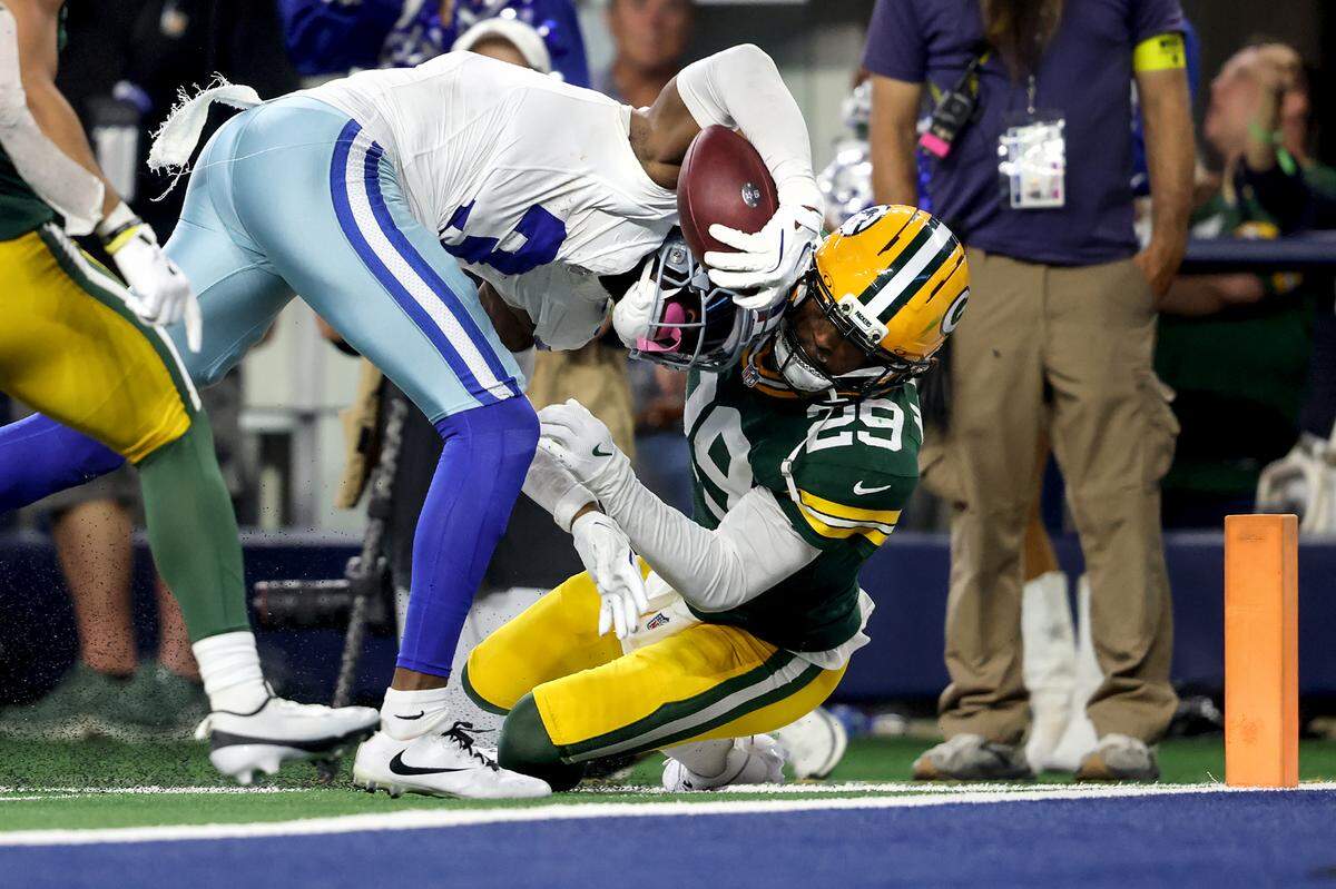 Dallas Cowboys wide receiver George Pickens pushes through Green Bay Packers safety Xavier McKinney to score a touchdown on Sunday.