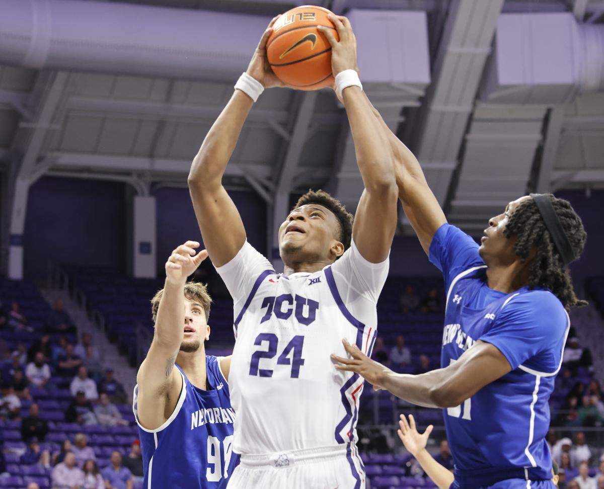 TCU forward Xavier Edmonds (24) shoots through double coverage during the first half of a NCAA basketball game between New Orleans University and TCU at Schollmaier Arena in Fort Worth, Texas, Monday Nov. 03, 2025. The Privateers led 44-28 at the half.
