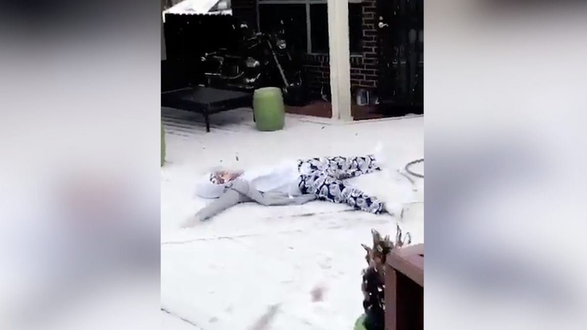 Houston resident Michelle Adamjee makes a snow angel during a January 2018 snow flurry.