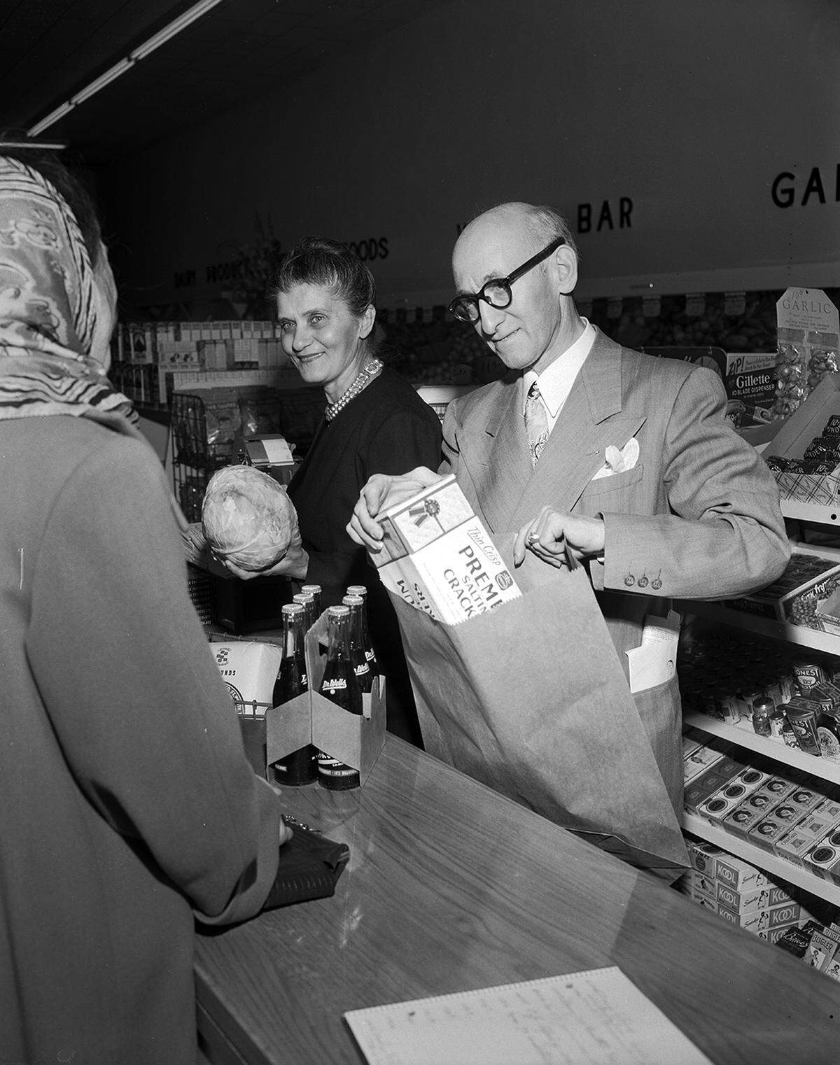 Feb. 9, 1950: Sherman’s Super Market, 1622 8th Ave. Mrs. Sam A. Nixon is being served by Mrs. Mooney J. Sherman, who is totaling the sale, and her husband is shown sacking the groceries. (The site today is Vascular & Interventional Specialists, at 8th Avenue and West Allen Street.)