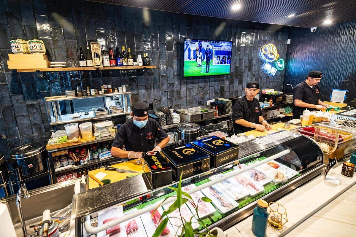 Sushi chefs Lawm Thang, John Thuang, and Martin Tojo make sushi orders for customers at Hush Sushi, Kitchen and Bar in Keller, Texas on Thursday, Aug. 24, 2023.