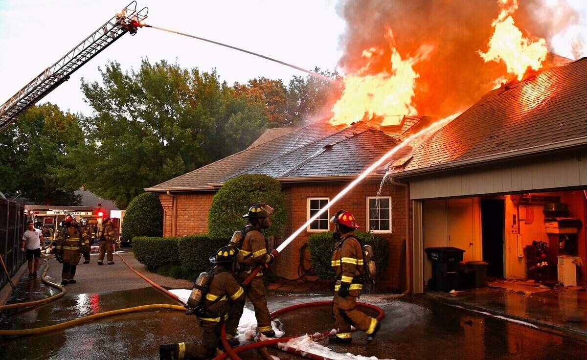 Fort Worth firefighters battle a blaze that enveloped at a home at 4900 Bradford Court on Monday evening. Three people were displaced as a result of the fire.
