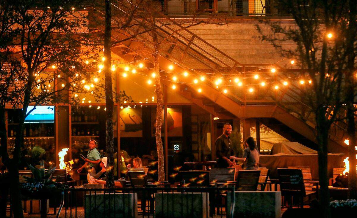 The patio at Press Cafe, located at The Trailhead at Clearfork, features fire pits and lighting for a pleasant evening.