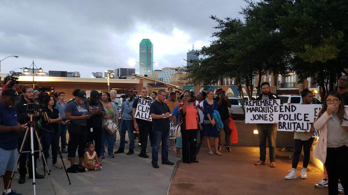 Those attending the vigil carried signs with the names of others who have been slain at the hands of police and end police brutality