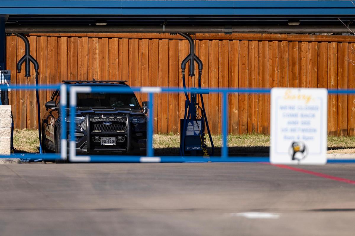 A law enforcement vehicle at the site of the Slappy’s Express Car Wash where Ronnie Sibley and his daughter R’mani, 5, were killed in Forest Hill, Texas.