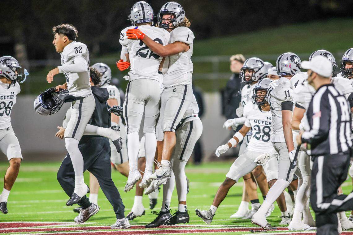 Denton Guyer’s Owen Whistler (22) and Kaedyn Cobbs jump to celebrate the Wildcats’ 24-21 victory over Byron Nelson in a Class 6A Division II regional semifinal Friday at Northwest ISD Stadium in Justin.