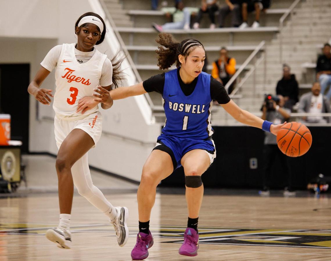 Fort Worth Boswell guard Camille Williams (1) almost looses the ball keeping it away from Lancaster forward Savanna Barnes (3) during the first half of the UIL Class 6A D2 state semifinal girls basketball game at The Colony High School in The Colony, Texas, Tuesday, Feb. 25, 2025.