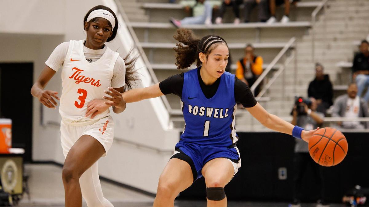 Fort Worth Boswell guard Camille Williams (1) almost looses the ball keeping it away from Lancaster forward Savanna Barnes (3) during the first half of the UIL Class 6A D2 state semifinal girls basketball game at The Colony High School in The Colony, Texas, Tuesday, Feb. 25, 2025.