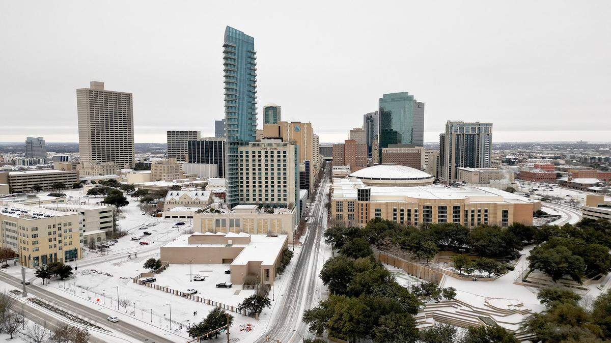 A thin layer of snow coats building and roads in downtown Fort Worth on Monday, January 15, 2024.