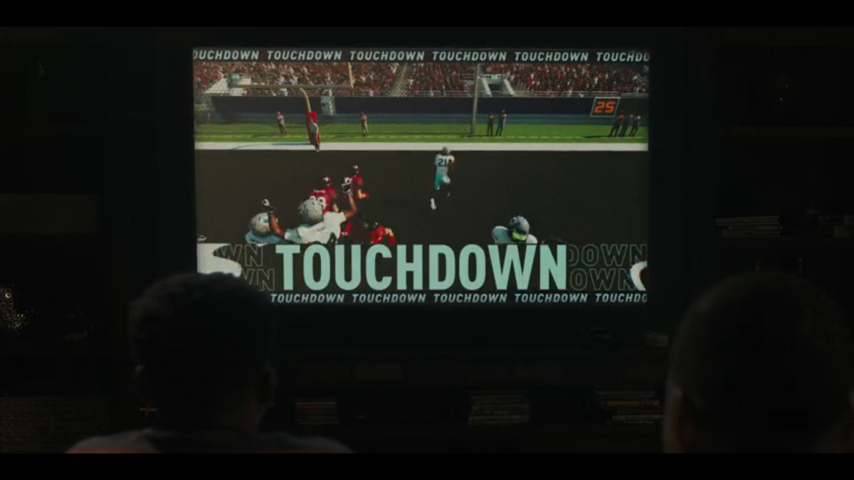 Boss (Mustafa Speaks) plays as the Dallas Cowboys in a football video game in “Landman” episode six.