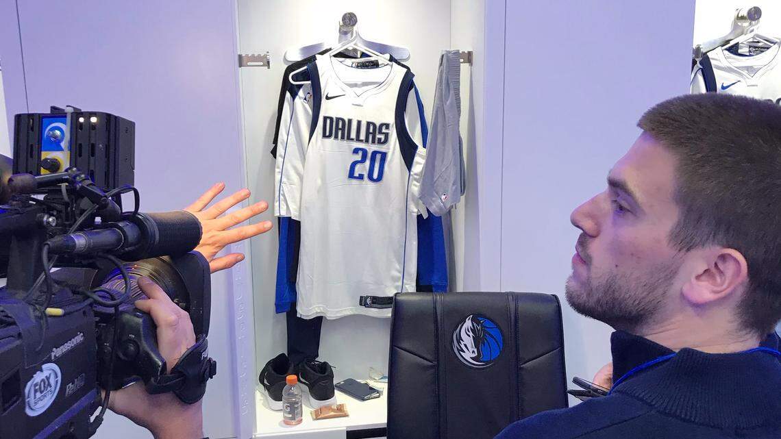 Members of the media wait for Doug McDermott at his locker before Saturday's game against the Los Angeles Lakers.