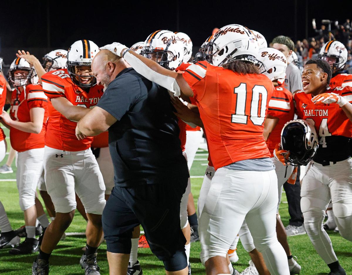 Haltom players celebrate the win with offensive line coach Monte Sparkman after a UIL District 8-6A football game at Birdville Fine Arts/Activity Complex in North Richland Hills, Texas, Thursday, Oct. 31, 2024.