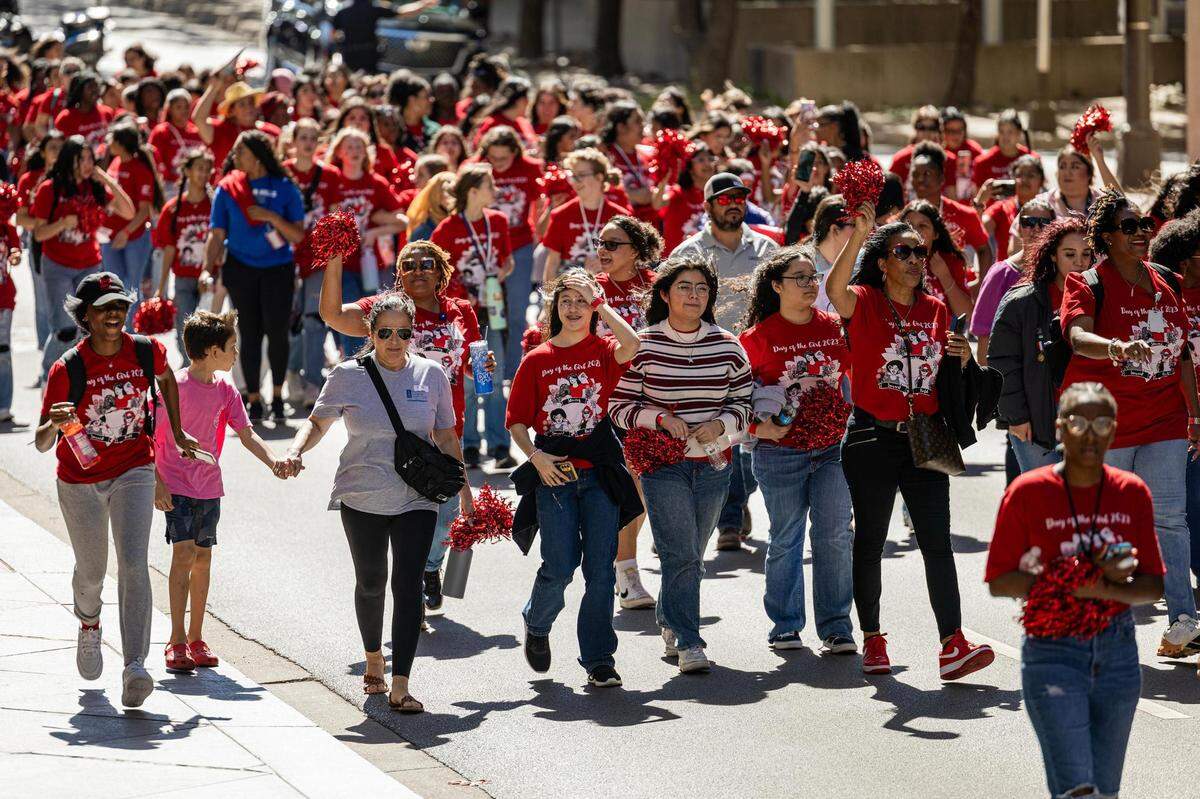 Thousands of women and members of the Girls Inc. of Tarrant County march down Cherry Street for the 2023 Day of the Girl march at Burnett Park in Fort Worth on Friday.