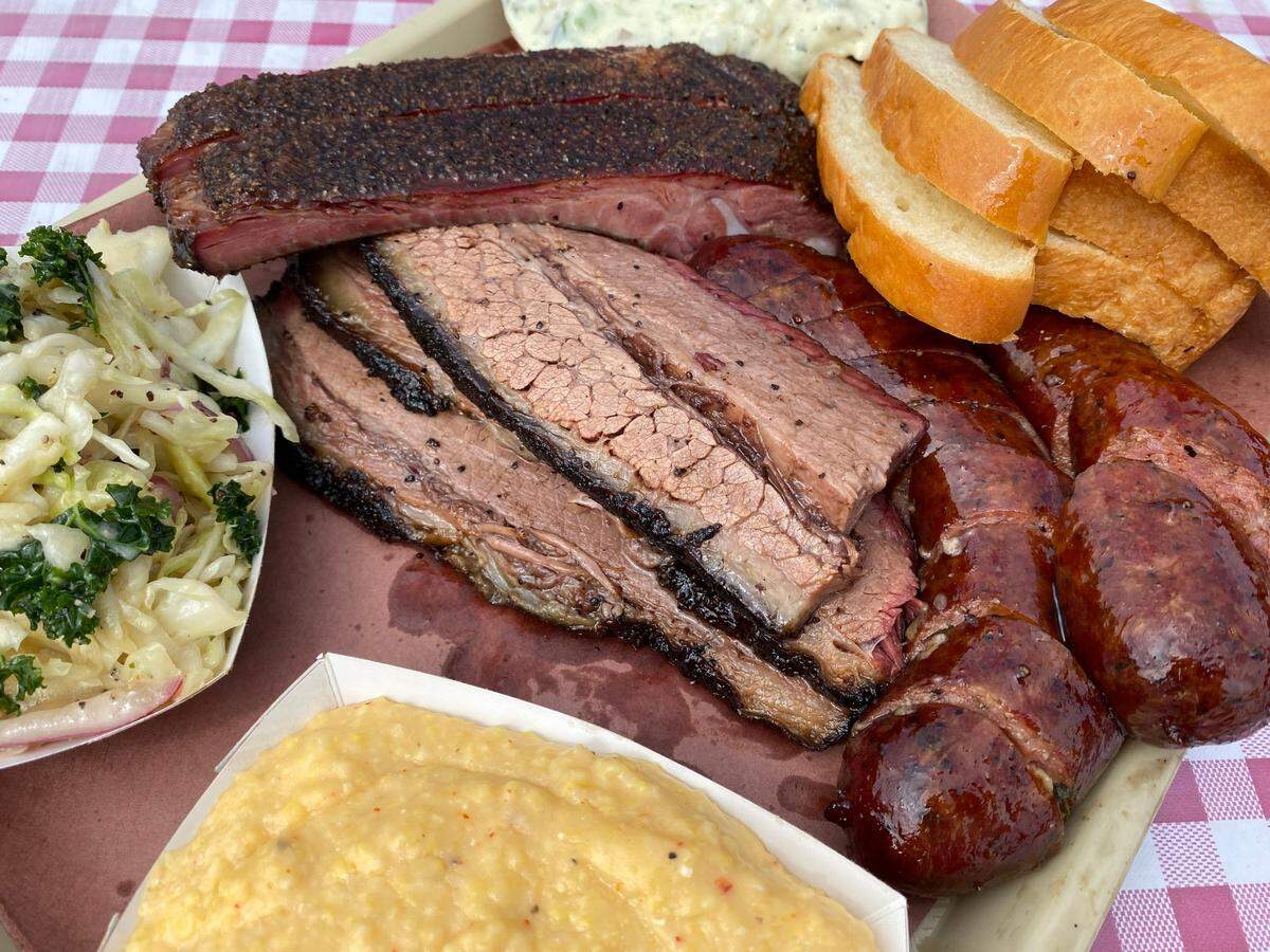 Brisket, sausage, ribs, cheese grits and slaw at Goldee’s Barbecue,