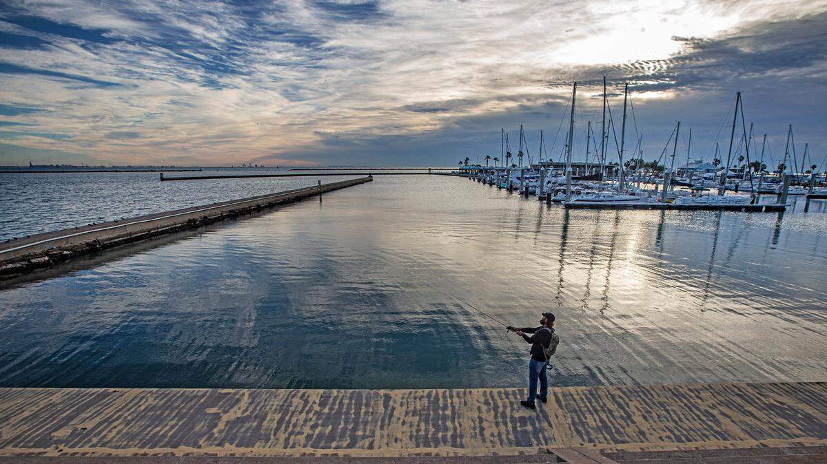 Tim Zuber cast a line along the seawall in Corpus Christi, Texas, Wednesday, Nov. 22, 2023. Zuber is from Portland, Texas, and loves coming out, “For pleasure and to get away from the wife for a few minutes,” he said laughing. Just down Zuber’s fishing spot are a series of beaches accessible from Ocean Drive in the heart of the city.