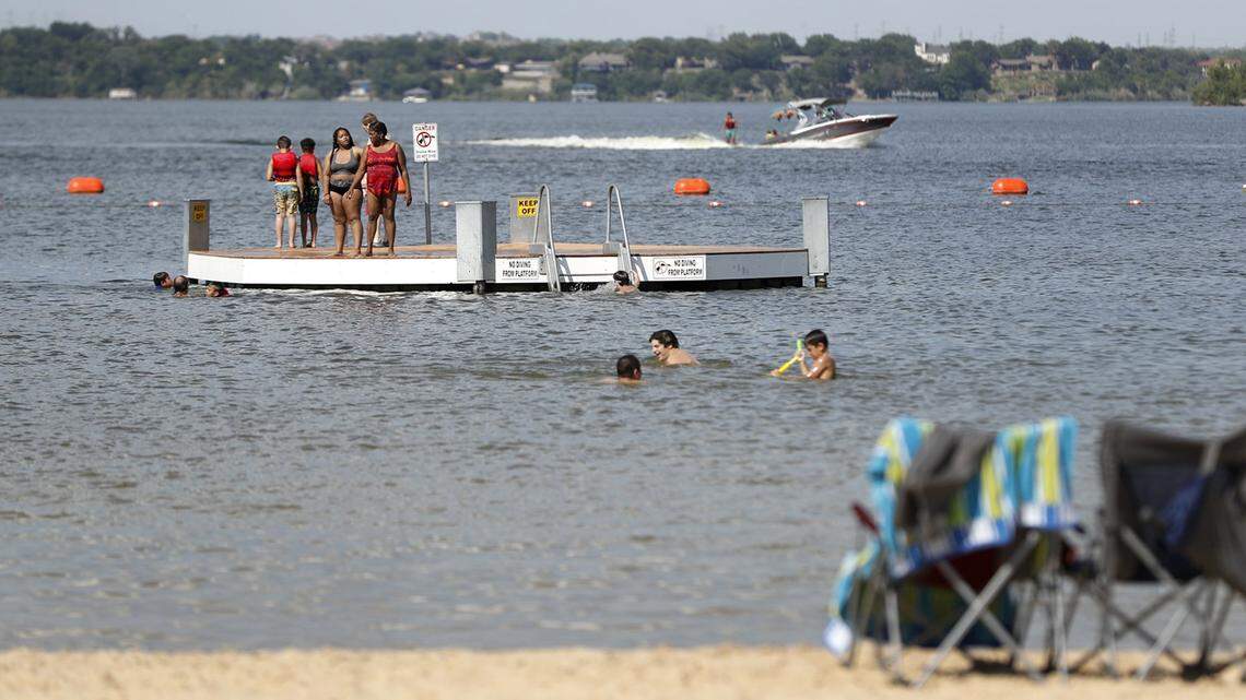 People stay cool in the summer heat at Twin Points Park at Eagle Mountain Lake on Tuesday, July 2, 2019. The park, which features a man-made beach, volleyball courts and charcoal grills, will have holiday pricing of $25 per car. It will close at 8 p.m. before fireworks are launched.