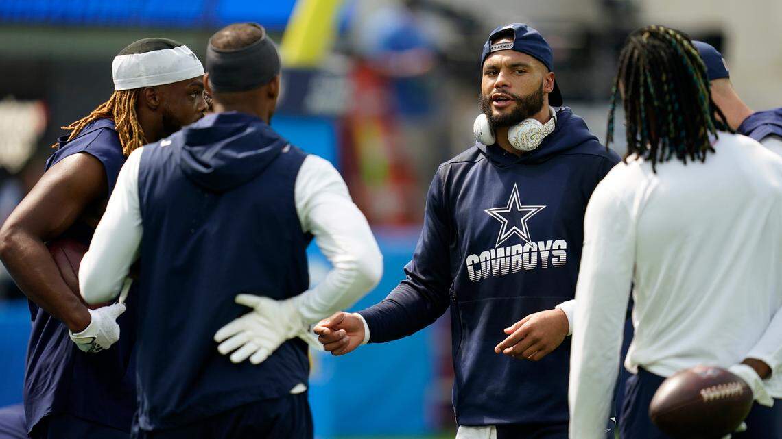 Dallas Cowboys quarterback Dak Prescott talks to teammates before playing the Los Angeles Chargers at SoFi Stadium on Sunday.