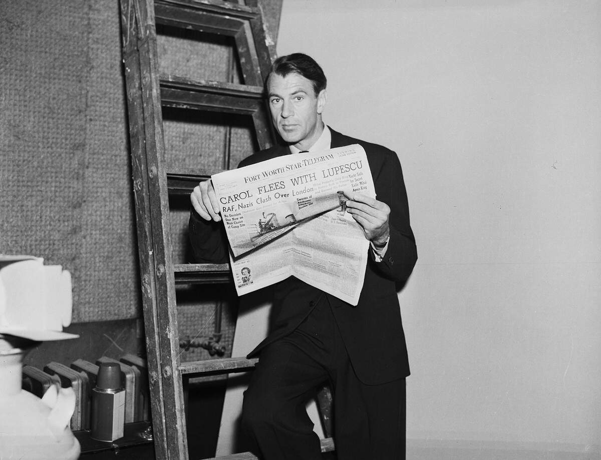 July 1940: Actor Gary Cooper reading a Fort Worth Star-Telegram newspaper.