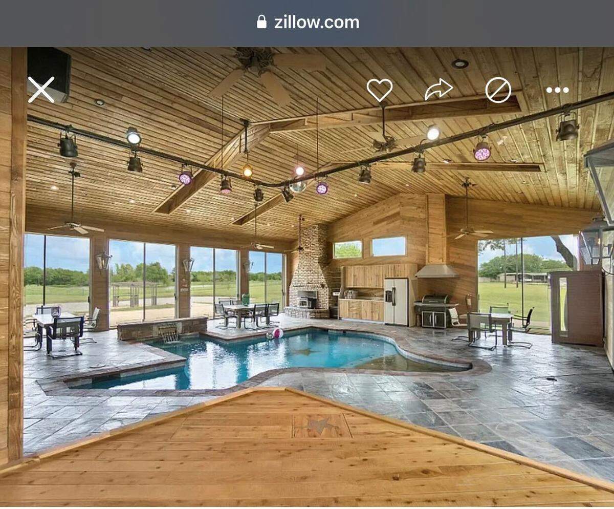 A house for sale in Royse City, Texas, has an indoor pool that’s shaped like Texas with a stage next to it.