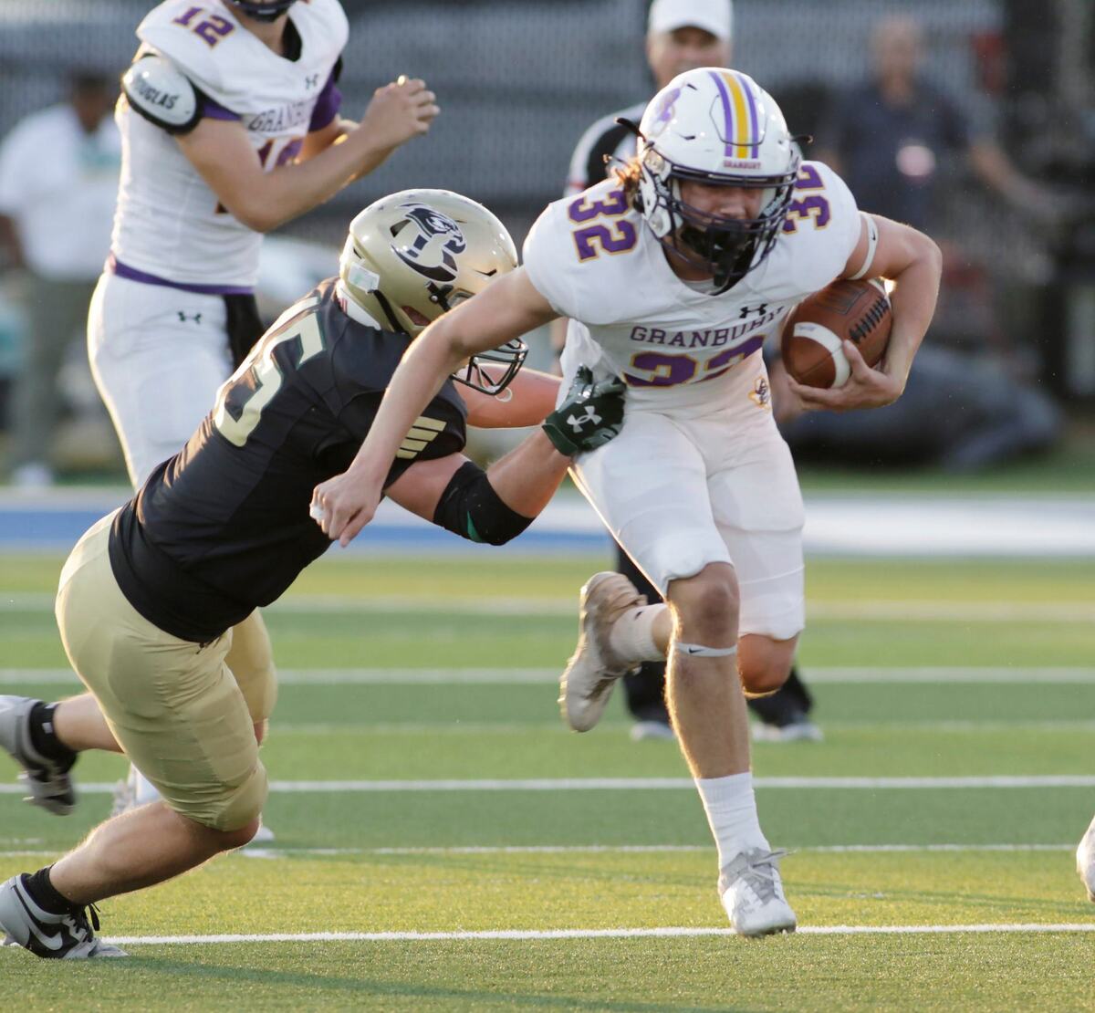 Grandbury’s Gage Archer breaks a tackle during their game Thursday night at Birdville Athletic Center. JOHN ROWLAND