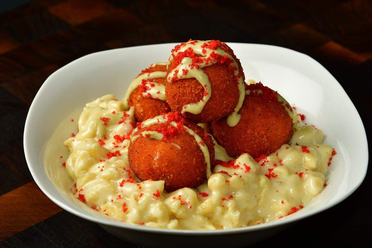 Cheetos mac-n-cheese balls at AT&T Stadium: Cheetos mac n cheese topped with fried mac-and-cheese “gems” with a crushed Jalapeño Cheddar Cheetos crust, drizzled with house-made jalapeño ranch and dusted with crushed Flamin’ Hot Cheetos